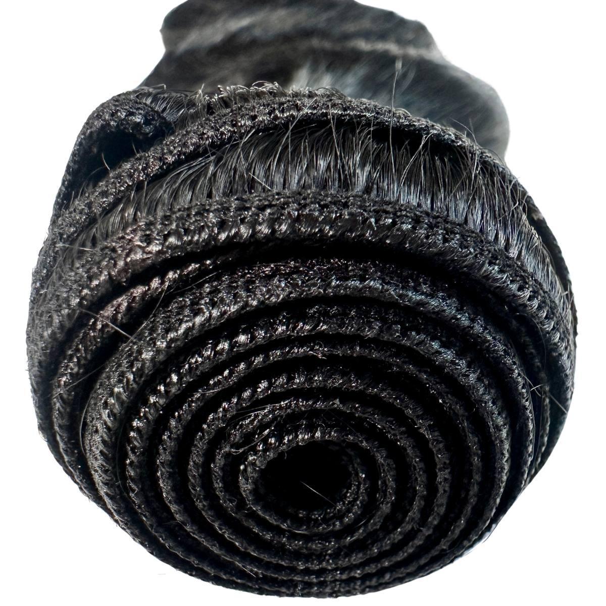 Close-up of jet black body wave hair bundles showing tight sewing and smooth texture from NEW BEAUTY DEPOT